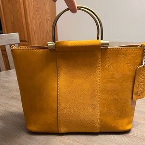 Mustard colored leather and suede top handle handbag from Altar’d State.